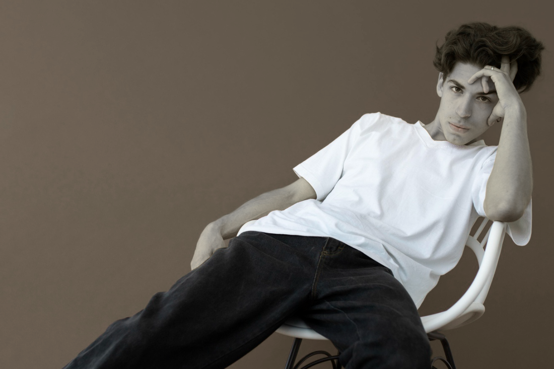 Young ]male model wearing oversized t-shirt in streetwear style representing modern fashion trend in Pakistan 2026.