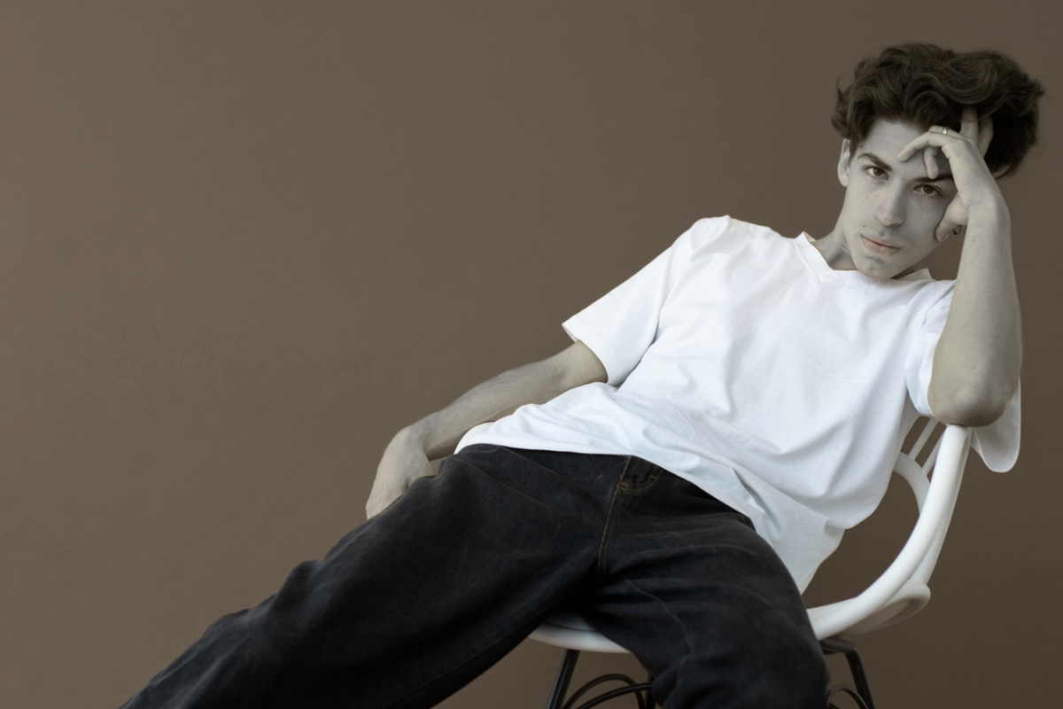 Young ]male model wearing oversized t-shirt in streetwear style representing modern fashion trend in Pakistan 2026.