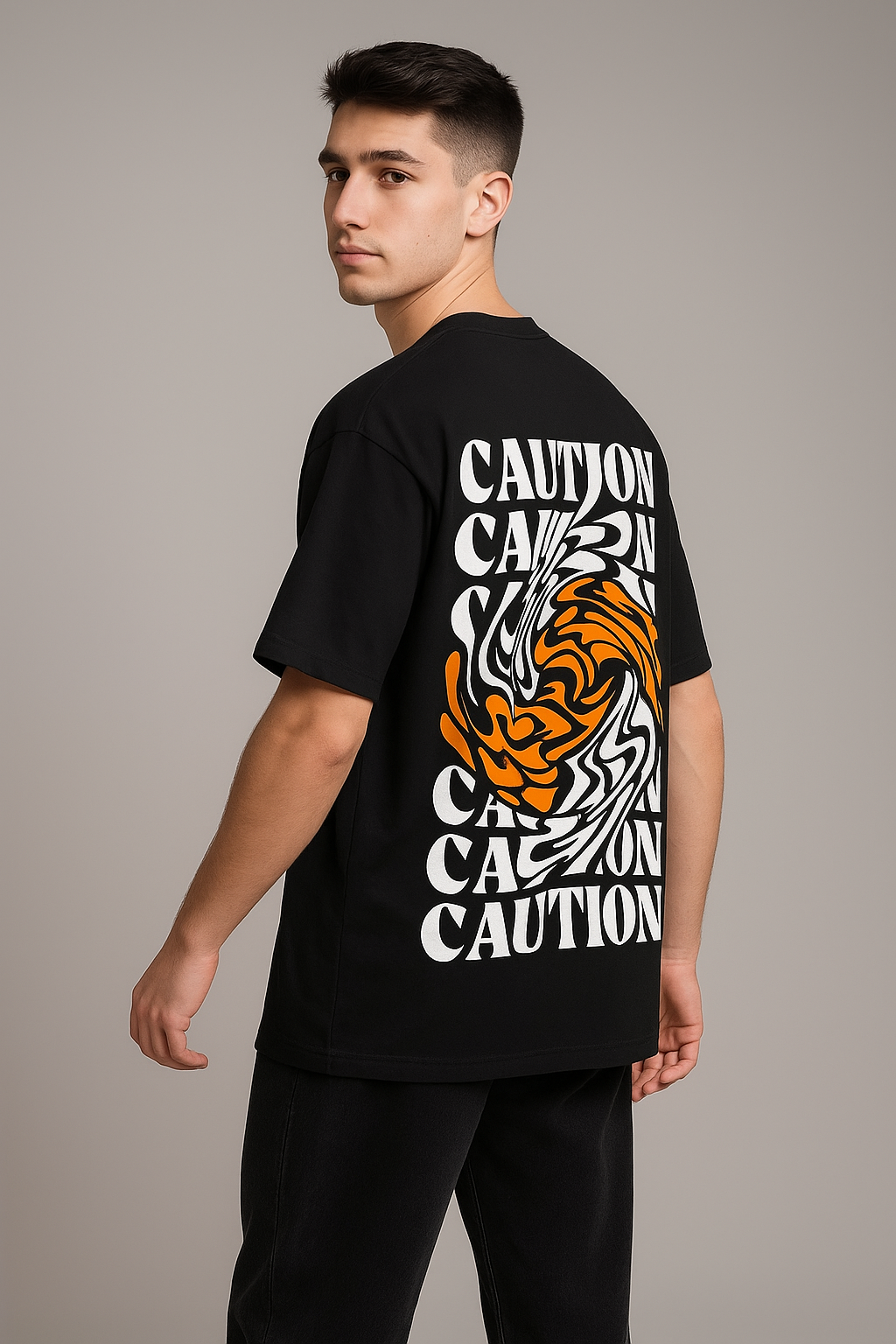 Person wearing a black t-shirt with a tiger design and 'CAUTION' text on the back against a gray background