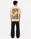 Styled back view of men’s beige t-shirt